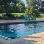 Orange Adirondack chair near pool edge