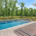 Outdoor pool with deck and lounge chairs