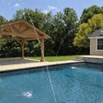 Backyard pool with water jets and gazebo
