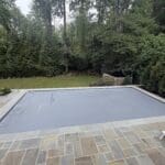 Covered swimming pool on stone patio