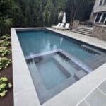 Modern backyard pool with attached spa